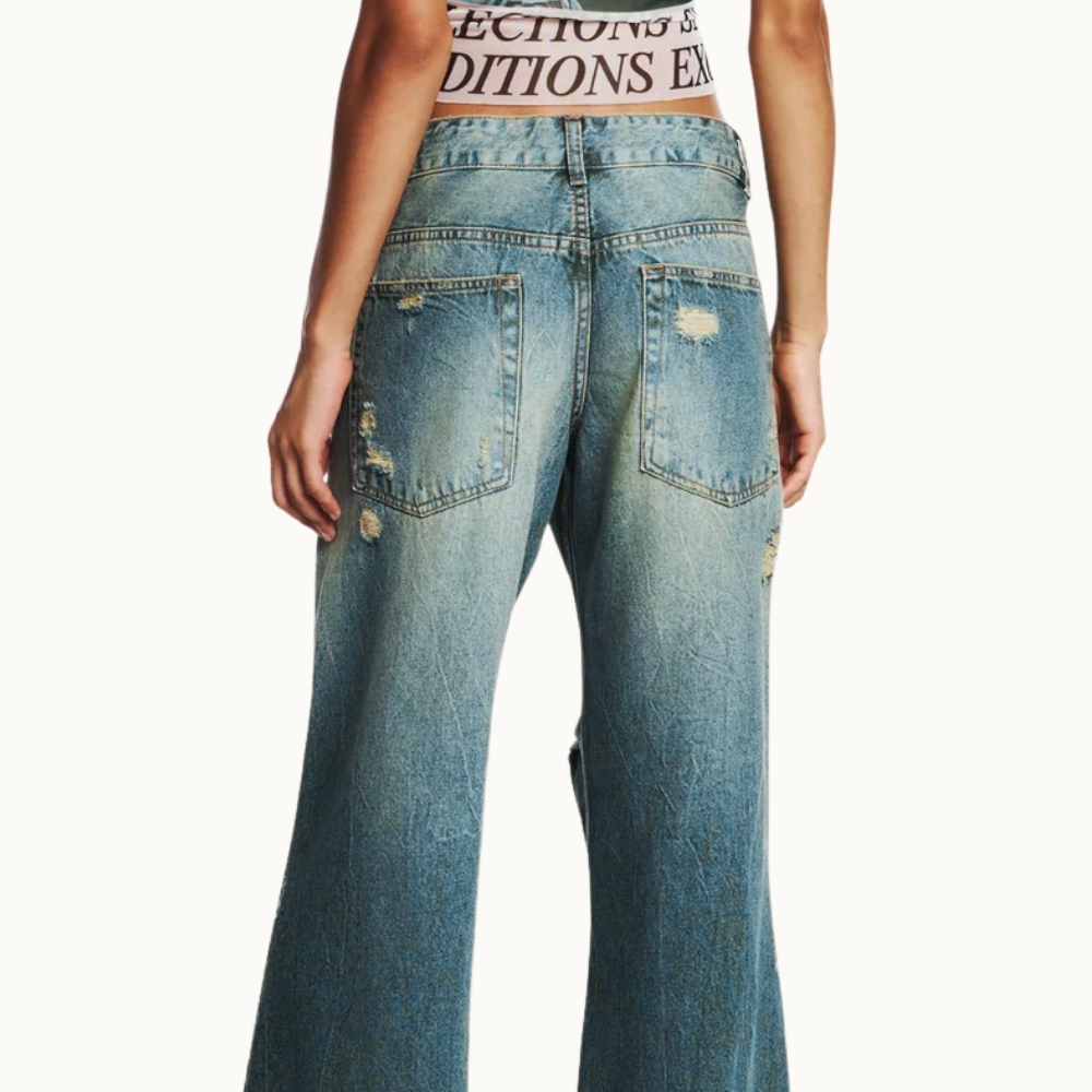 CALÇA JEANS AMARELADA RASGOS FLARE CINTURA BAIXA